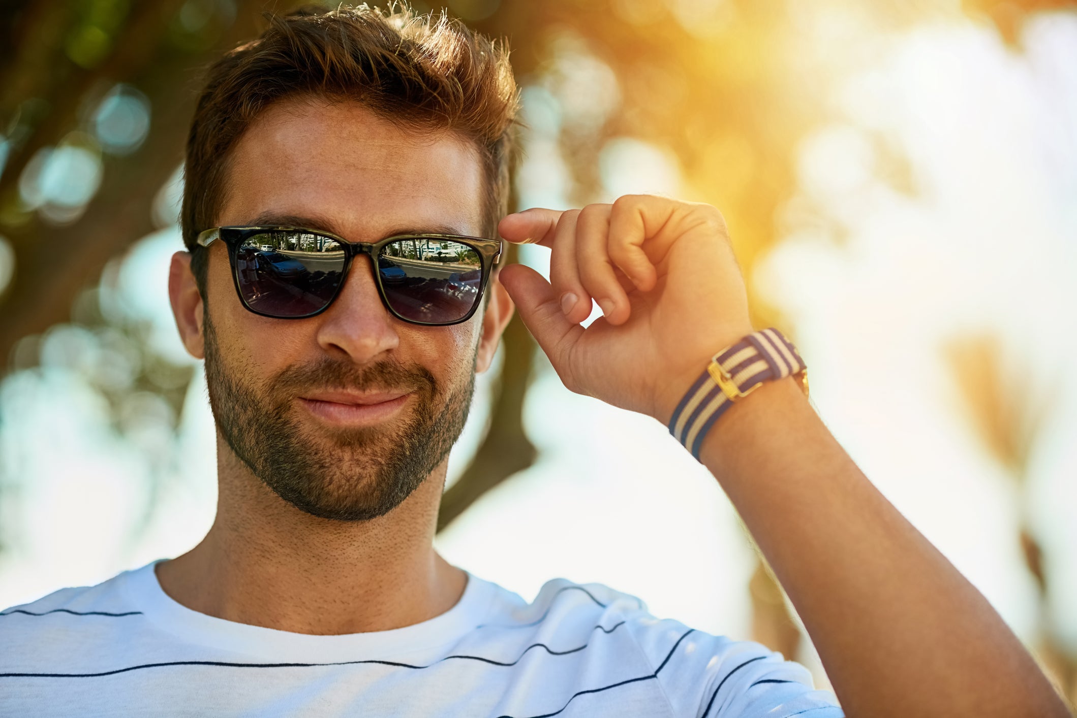 Portrait Of Young Man Wearing Mirrored Polarized Sunglasses At